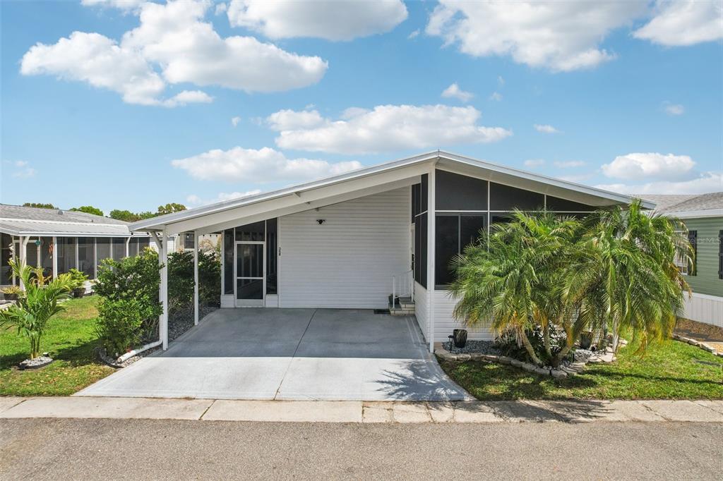 358 Lake Way Oldsmar, FL 34677 - Photo 33 of 48 a front view of a house with garden