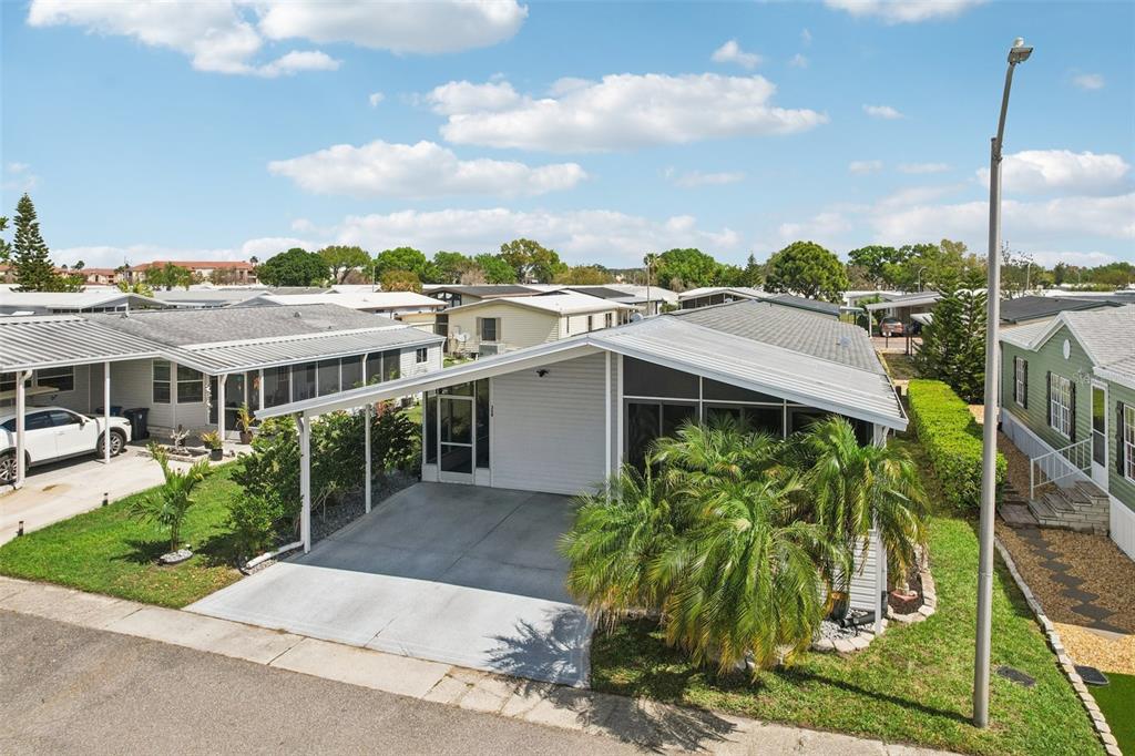 358 Lake Way Oldsmar, FL 34677 - Photo 34 of 48 a view of a patio with table and chairs potted plants with wooden fence