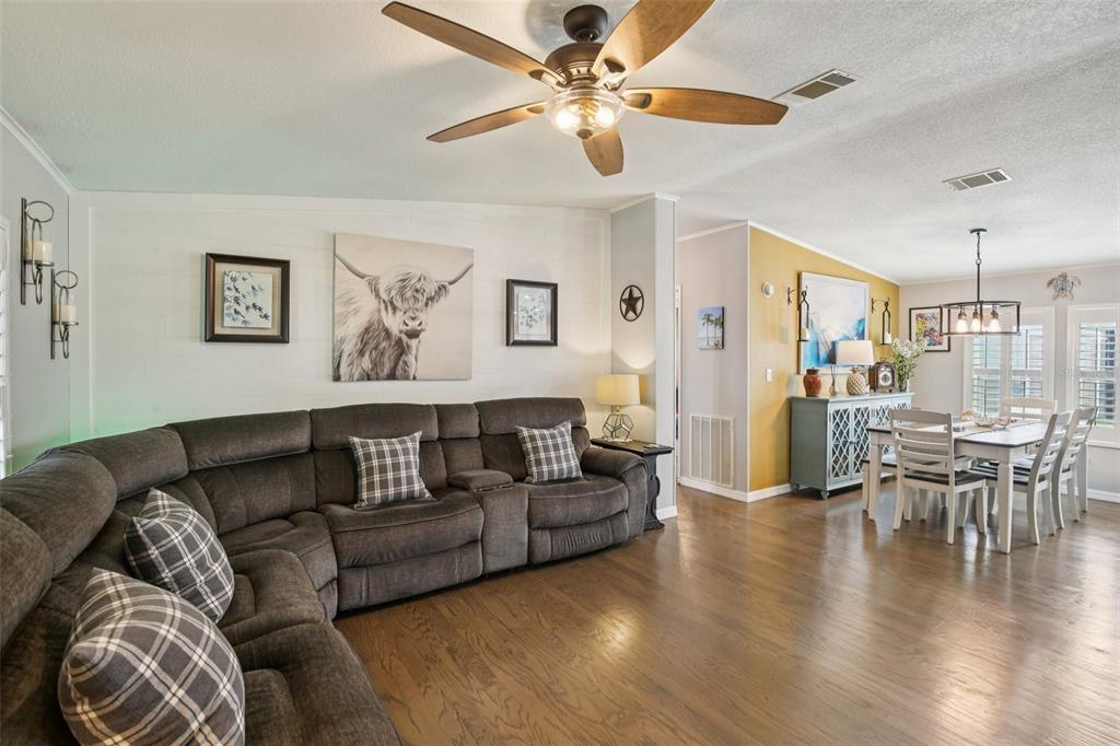 358 Lake Way Oldsmar, FL 34677 - Photo 8 of 48 a living room with furniture or wooden floor and a chandelier