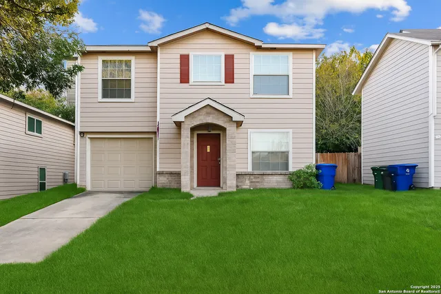 a front view of a house with a garden and yard