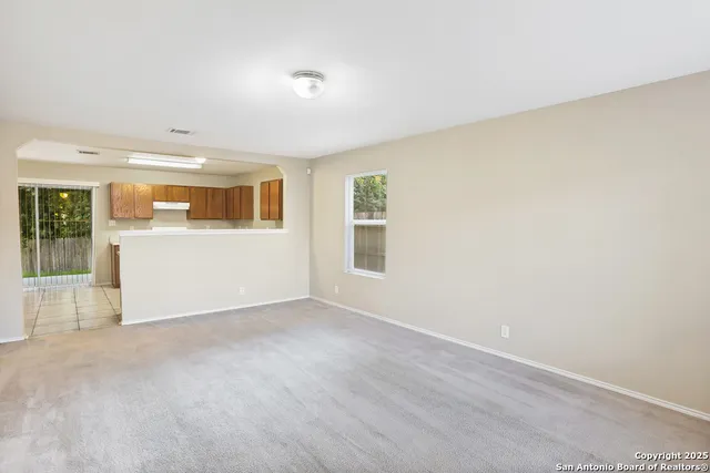 an empty room with a empty space and windows