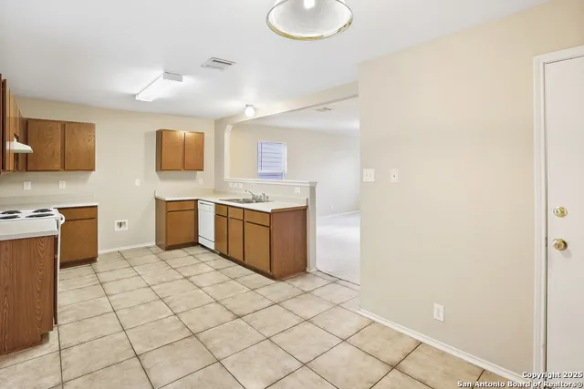 a kitchen with stainless steel appliances a sink and cabinets
