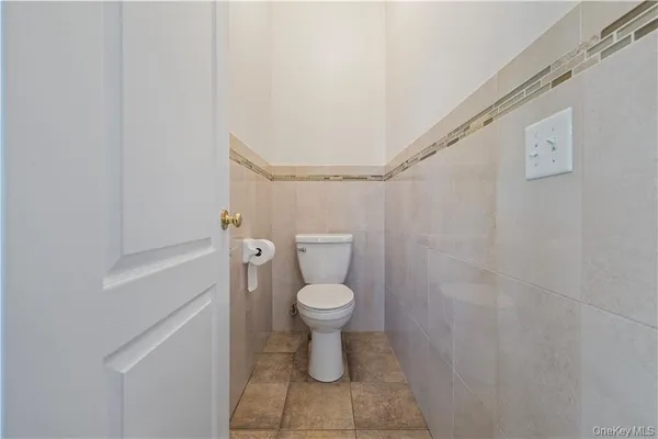 a white toilet sitting next to a white sink