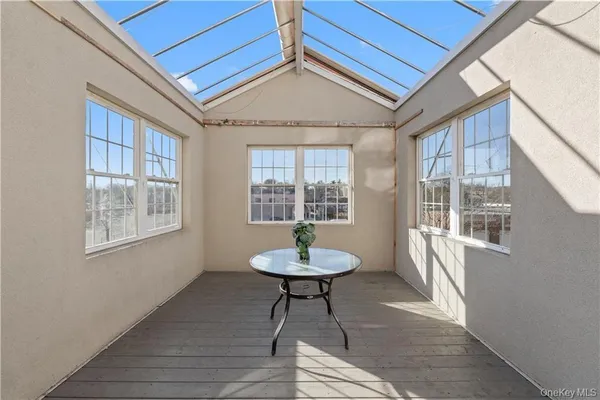 a room with a chandelier and a window
