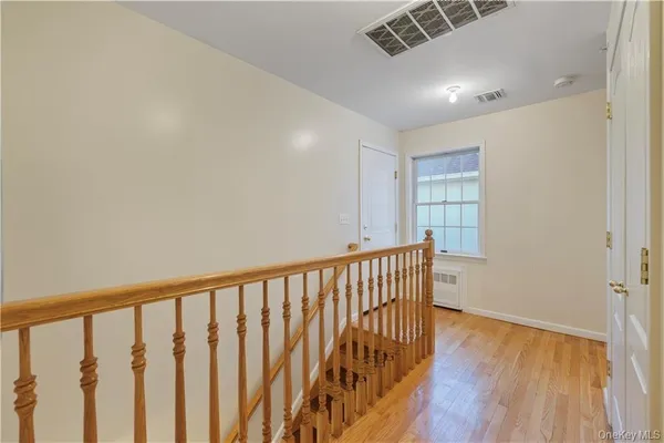 a view of hallway with wooden floor
