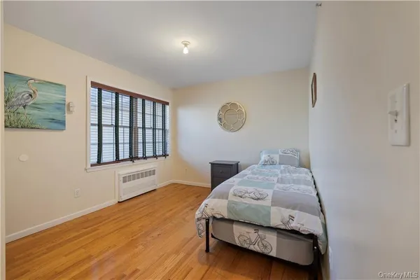 a bedroom with bed and a window