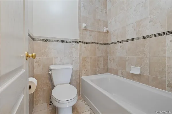 a bathroom with a granite countertop toilet a sink and bathtub
