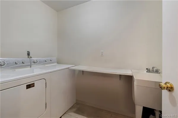 a utility room with cabinets washer and dryer