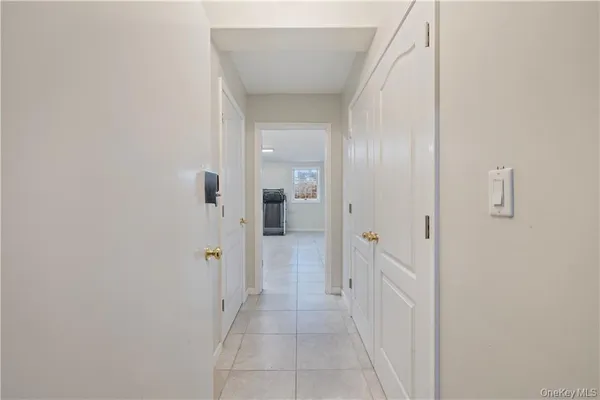 a view of a hallway with wooden shelves
