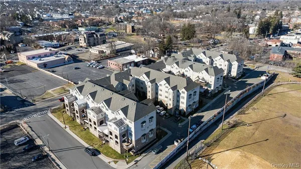 an aerial view of a residential apartment building with parking space
