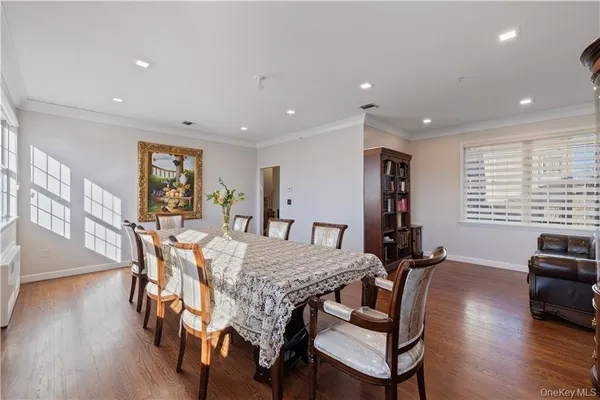 a view of a dining room with furniture window and wooden floor