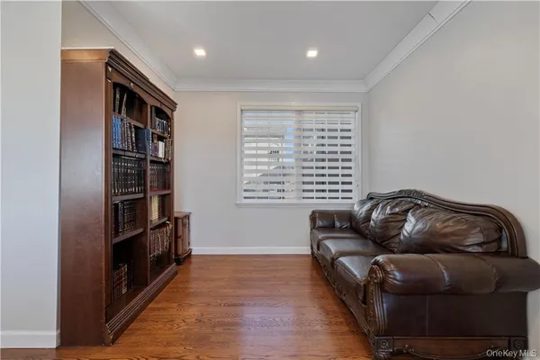 a living room with furniture and a hard wood floor