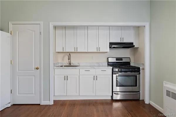 a kitchen with stainless steel appliances granite countertop a stove and a refrigerator