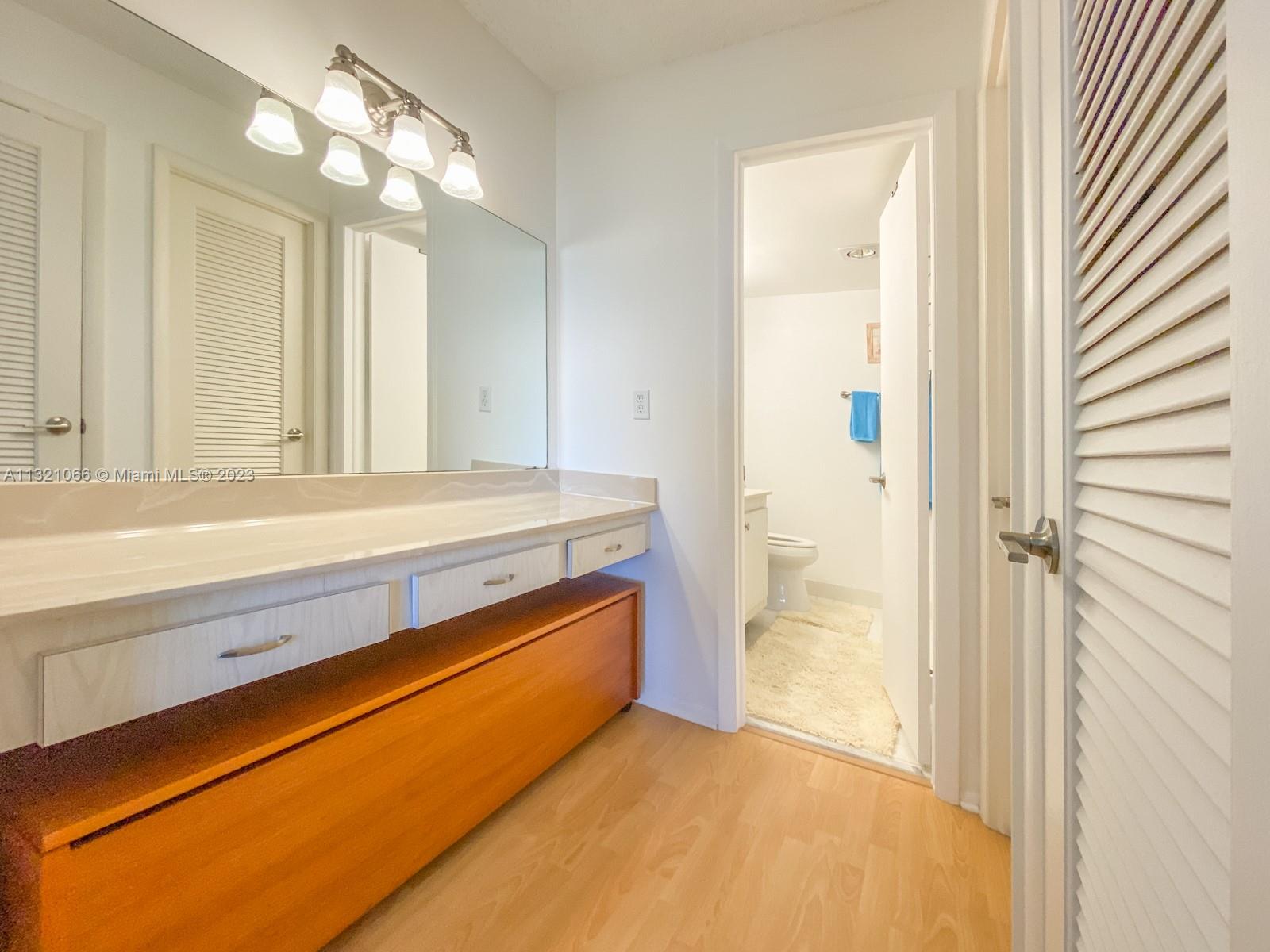 250 Northwest 67th Street, Unit 417 Boca Raton, FL 33487 - Photo 14 of 27 a bathroom with a sink and a mirror