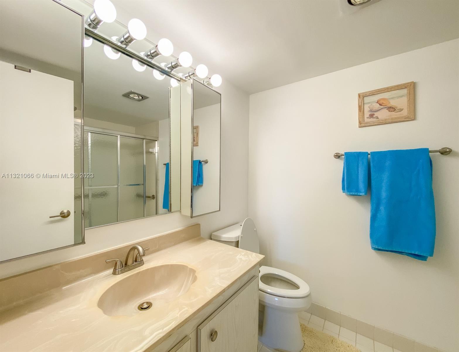 250 Northwest 67th Street, Unit 417 Boca Raton, FL 33487 - Photo 15 of 27 a bathroom with a granite countertop sink a toilet and mirror