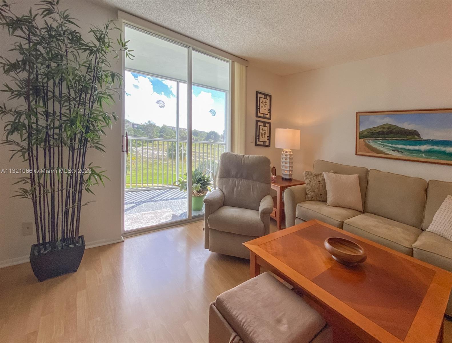 250 Northwest 67th Street, Unit 417 Boca Raton, FL 33487 - Photo 19 of 27 a living room with furniture and a floor to ceiling window