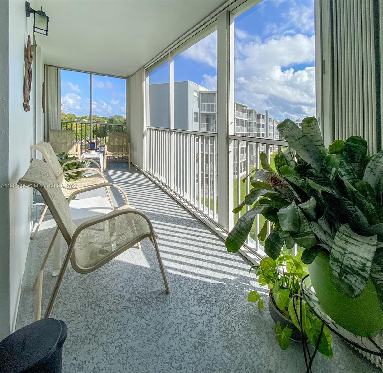 250 Northwest 67th Street, Unit 417 Boca Raton, FL 33487 - Photo 20 of 27 a building outdoor space with patio furniture