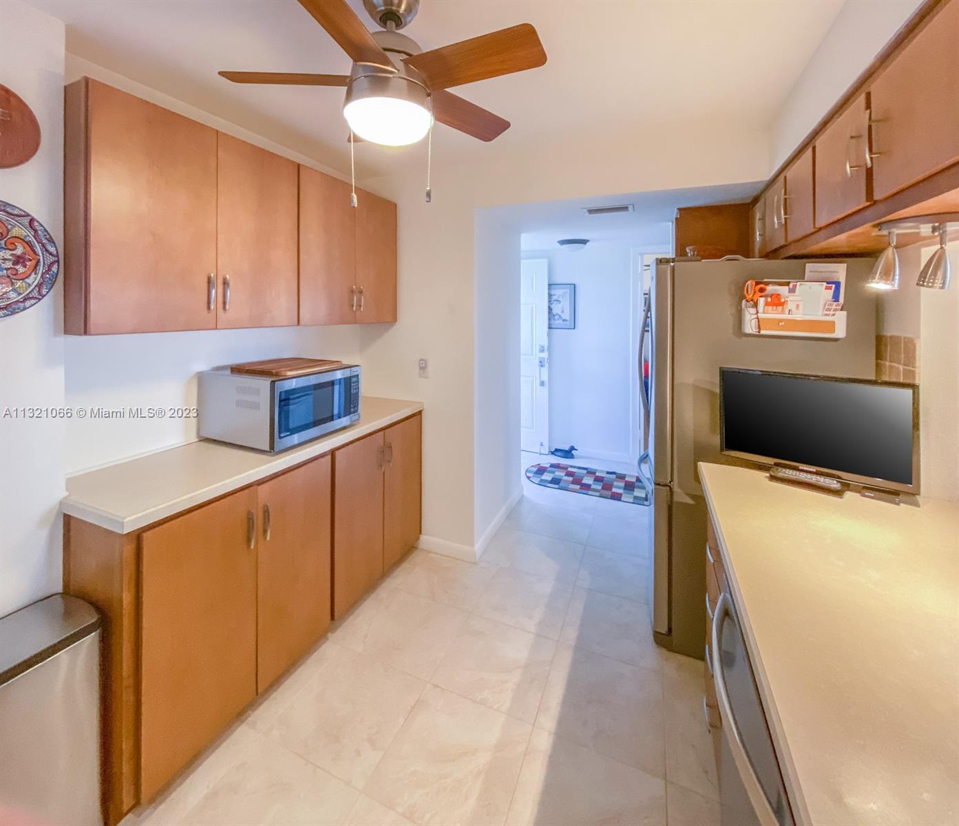 250 Northwest 67th Street, Unit 417 Boca Raton, FL 33487 - Photo 3 of 27 a kitchen with stainless steel appliances cabinets and a refrigerator