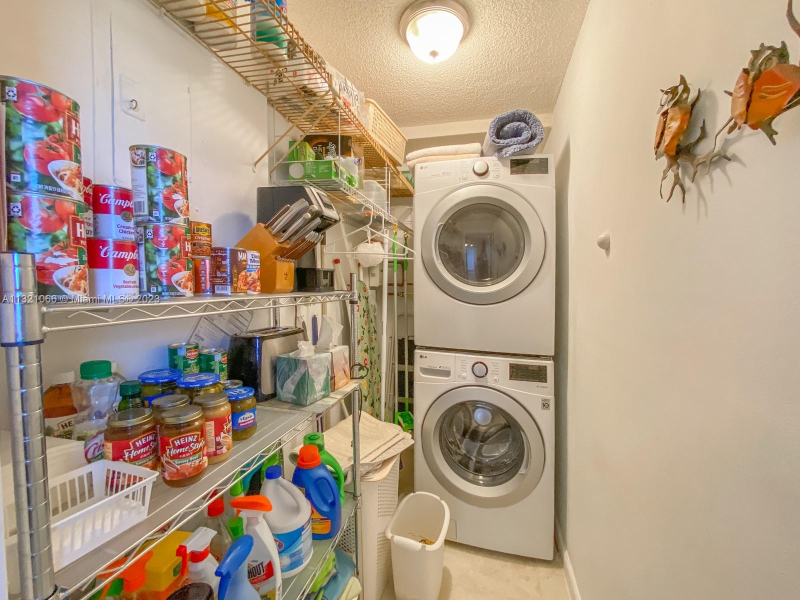 250 Northwest 67th Street, Unit 417 Boca Raton, FL 33487 - Photo 4 of 27 a utility room with toys and wooden floor