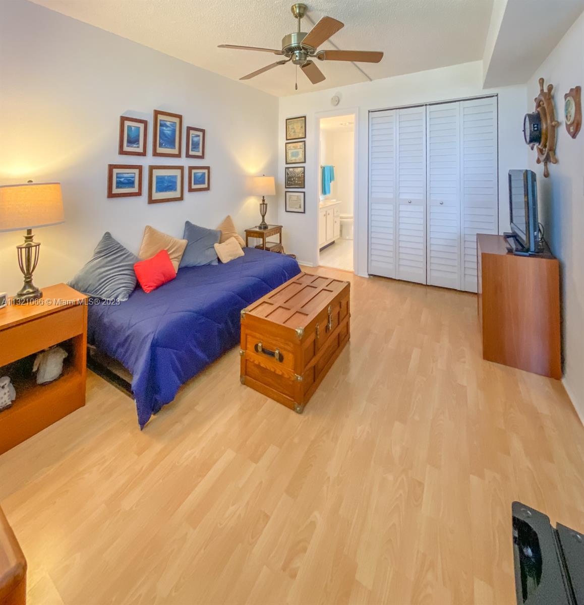 250 Northwest 67th Street, Unit 417 Boca Raton, FL 33487 - Photo 5 of 27 a living room with a bed and furniture