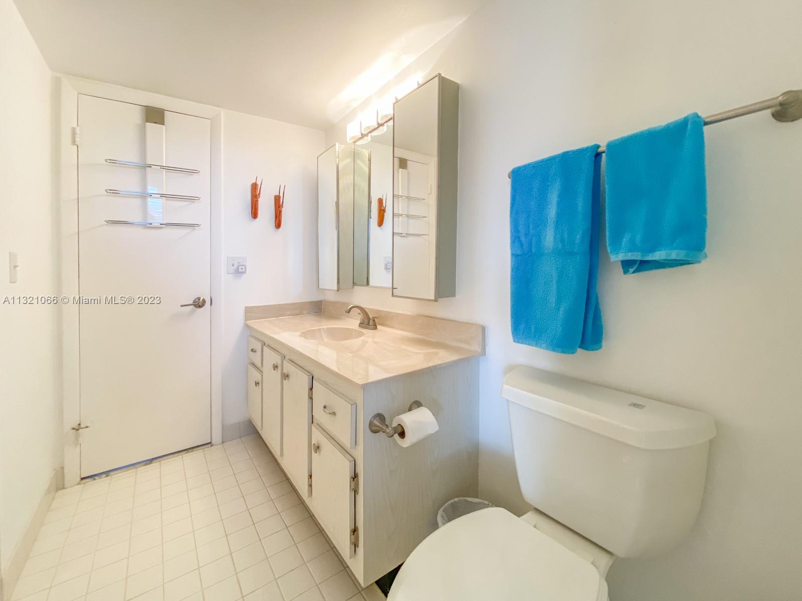 250 Northwest 67th Street, Unit 417 Boca Raton, FL 33487 - Photo 7 of 27 a bathroom with a sink a toilet and shower