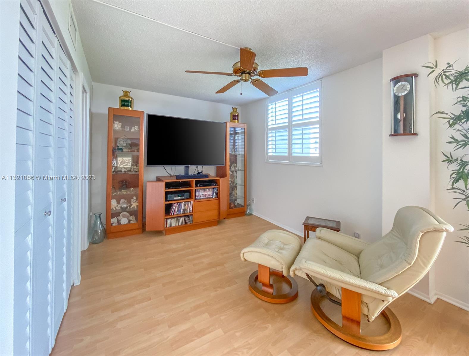250 Northwest 67th Street, Unit 417 Boca Raton, FL 33487 - Photo 9 of 27 a view of a livingroom with furniture and a flat screen tv