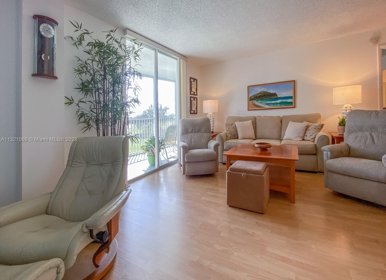 250 Northwest 67th Street, Unit 417 Boca Raton, FL 33487 - Photo 10 of 27 a living room with furniture and a large window