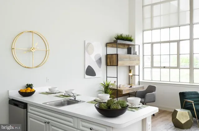 a dining room with wooden floor and a potted plant