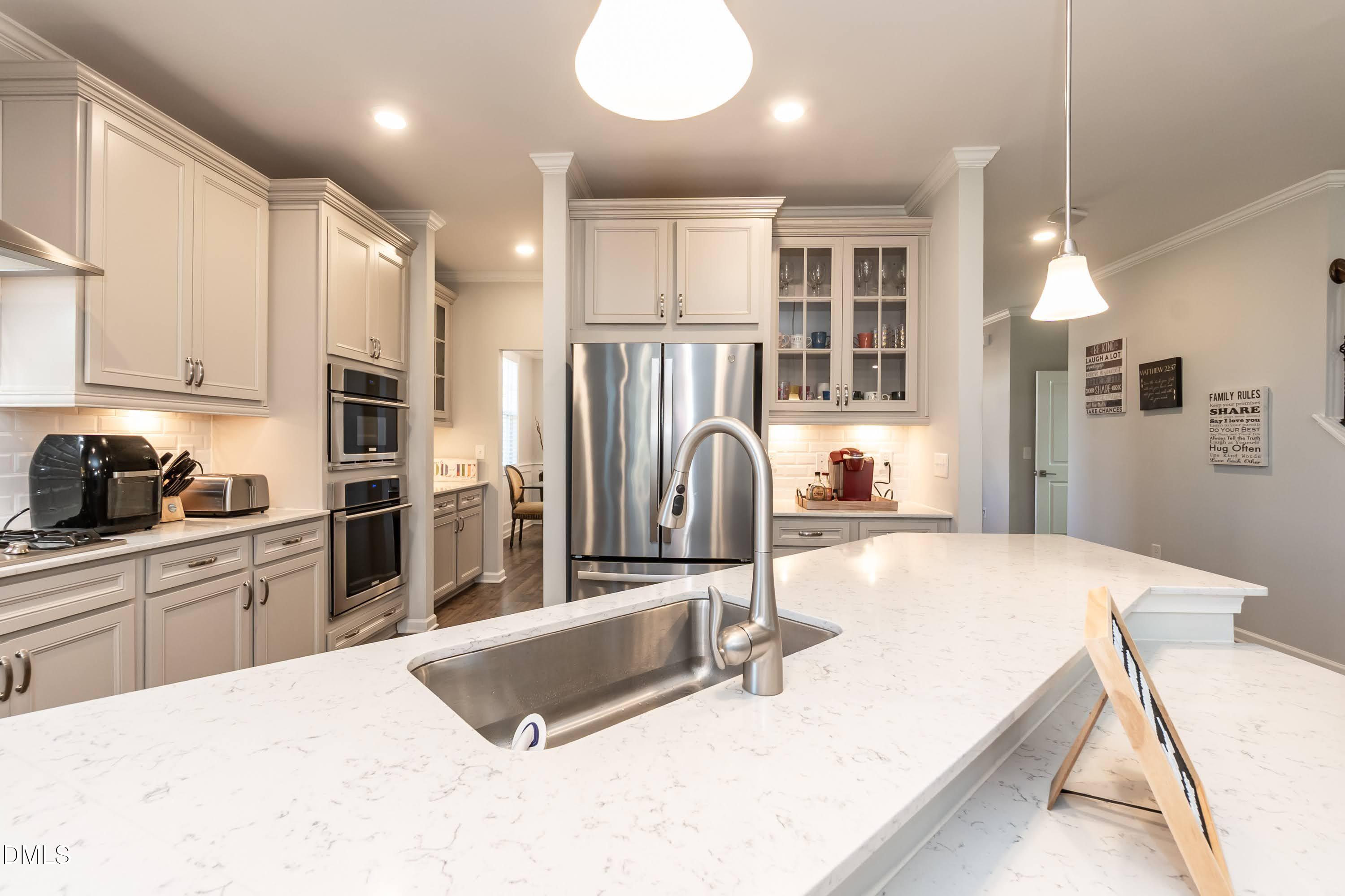 1009 Crescent Moon Court Durham, NC 27712 - Photo 28 of 57 a kitchen with stainless steel appliances granite countertop a sink refrigerator and cabinets