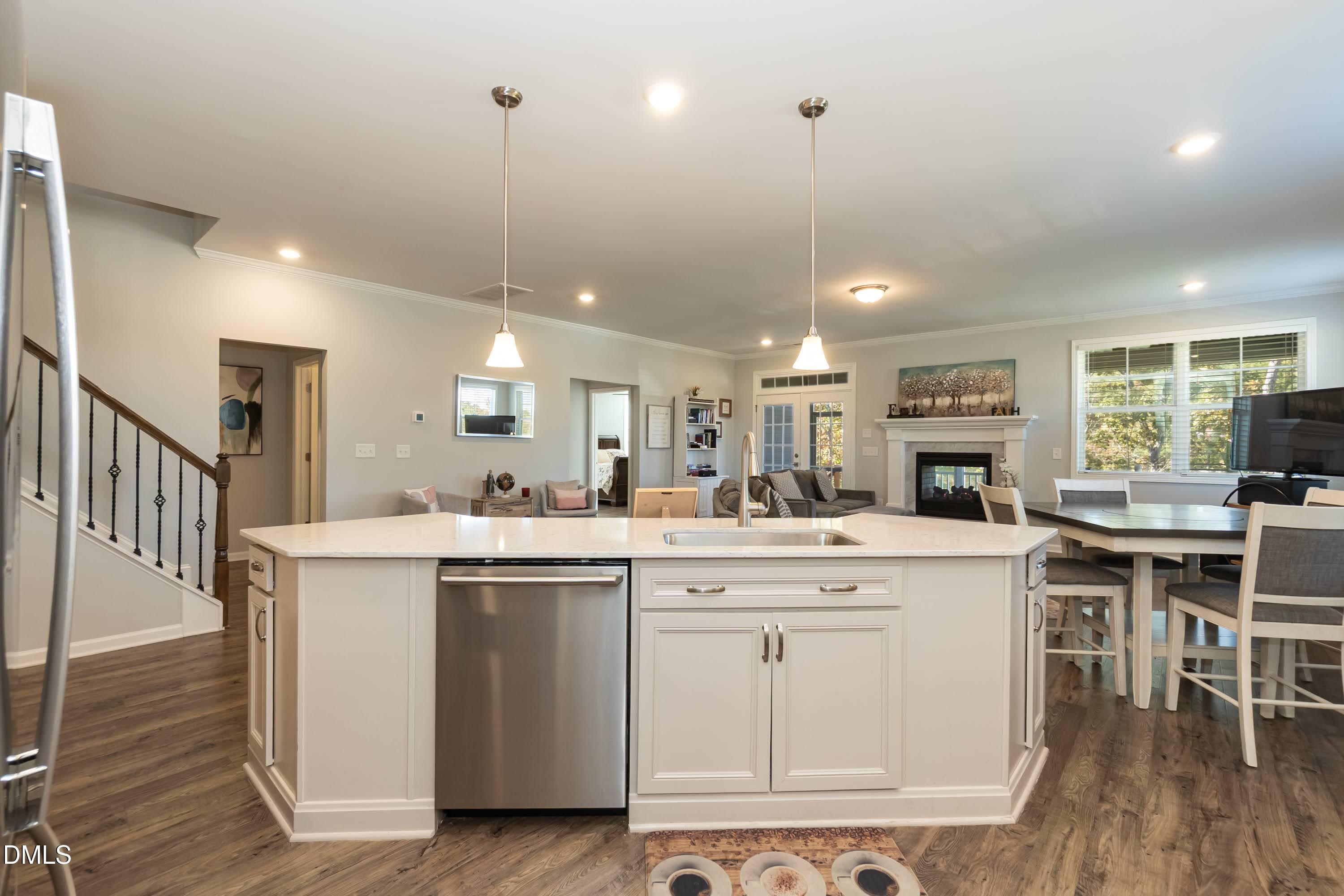 1009 Crescent Moon Court Durham, NC 27712 - Photo 29 of 57 a kitchen with kitchen island a stove a table and chairs in it