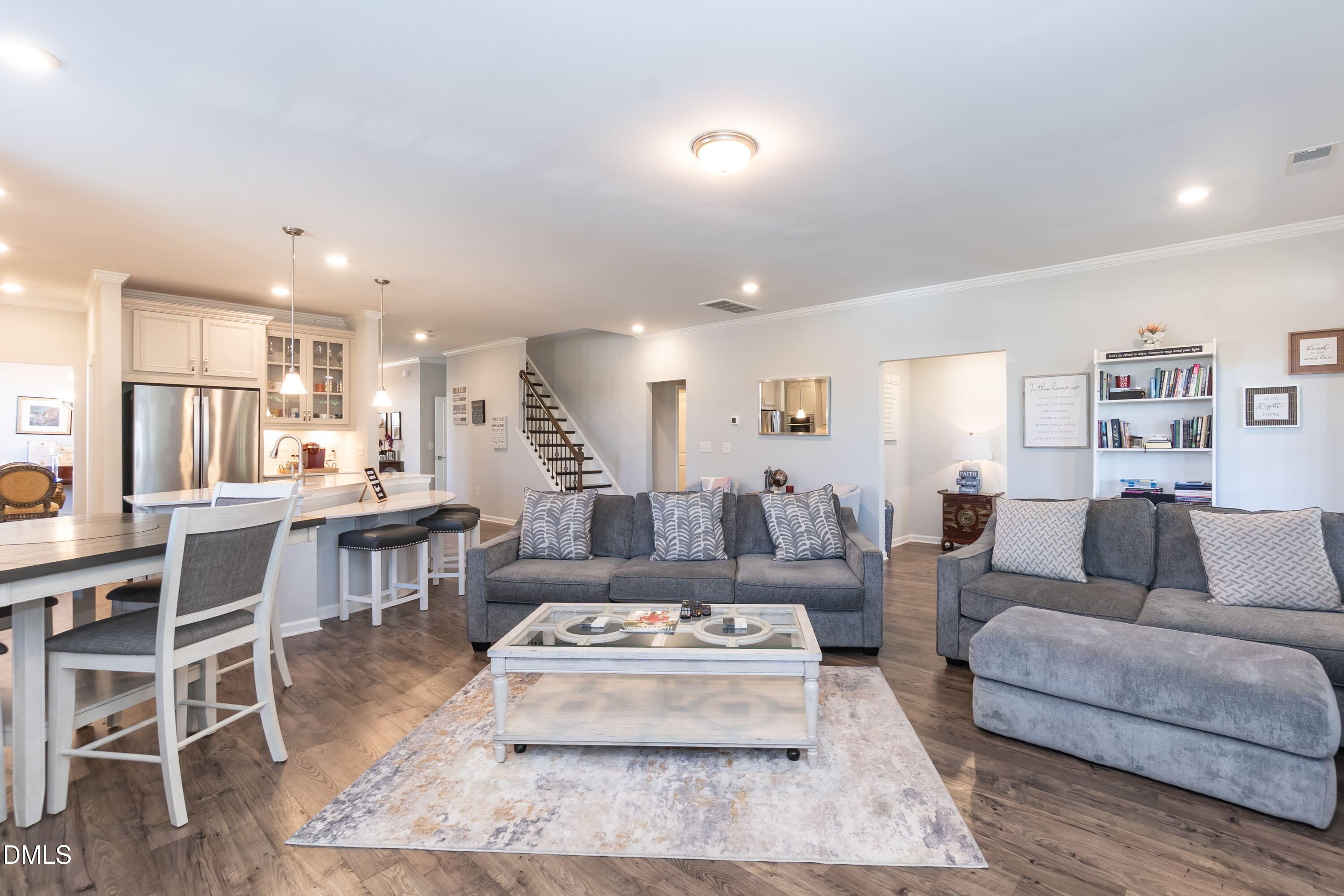 1009 Crescent Moon Court Durham, NC 27712 - Photo 35 of 57 a living room with furniture and a dining table with wooden floor