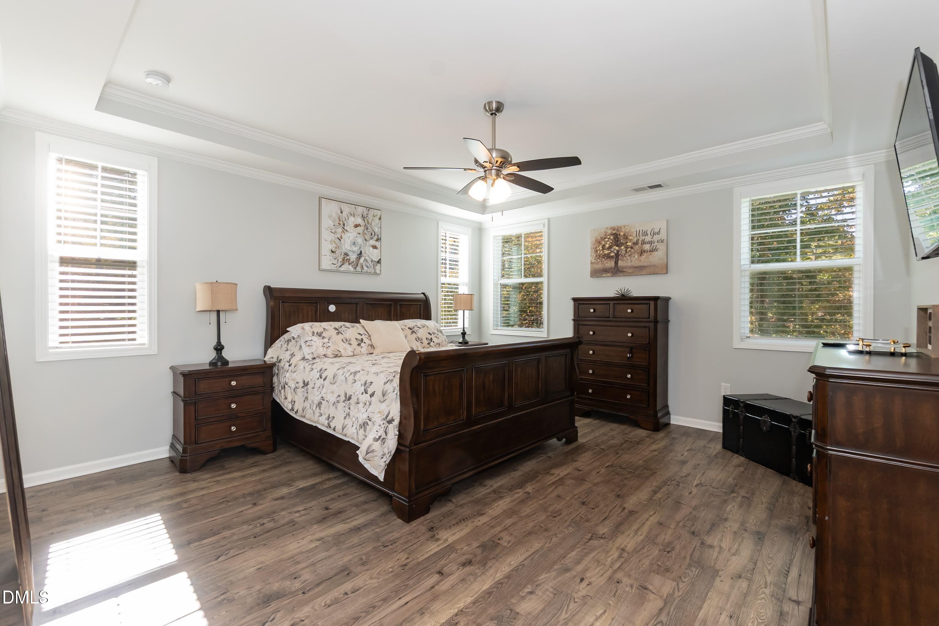 1009 Crescent Moon Court Durham, NC 27712 - Photo 39 of 57 a bedroom with a bed and a dresser next to a window