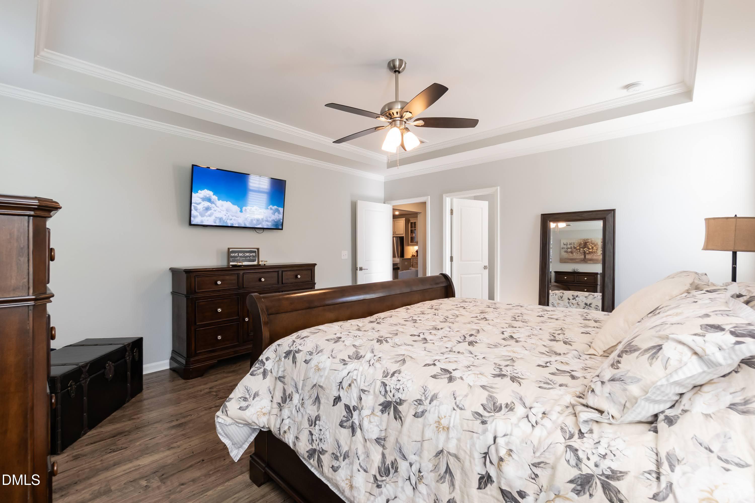 1009 Crescent Moon Court Durham, NC 27712 - Photo 41 of 57 a bedroom with a bed and wooden floor