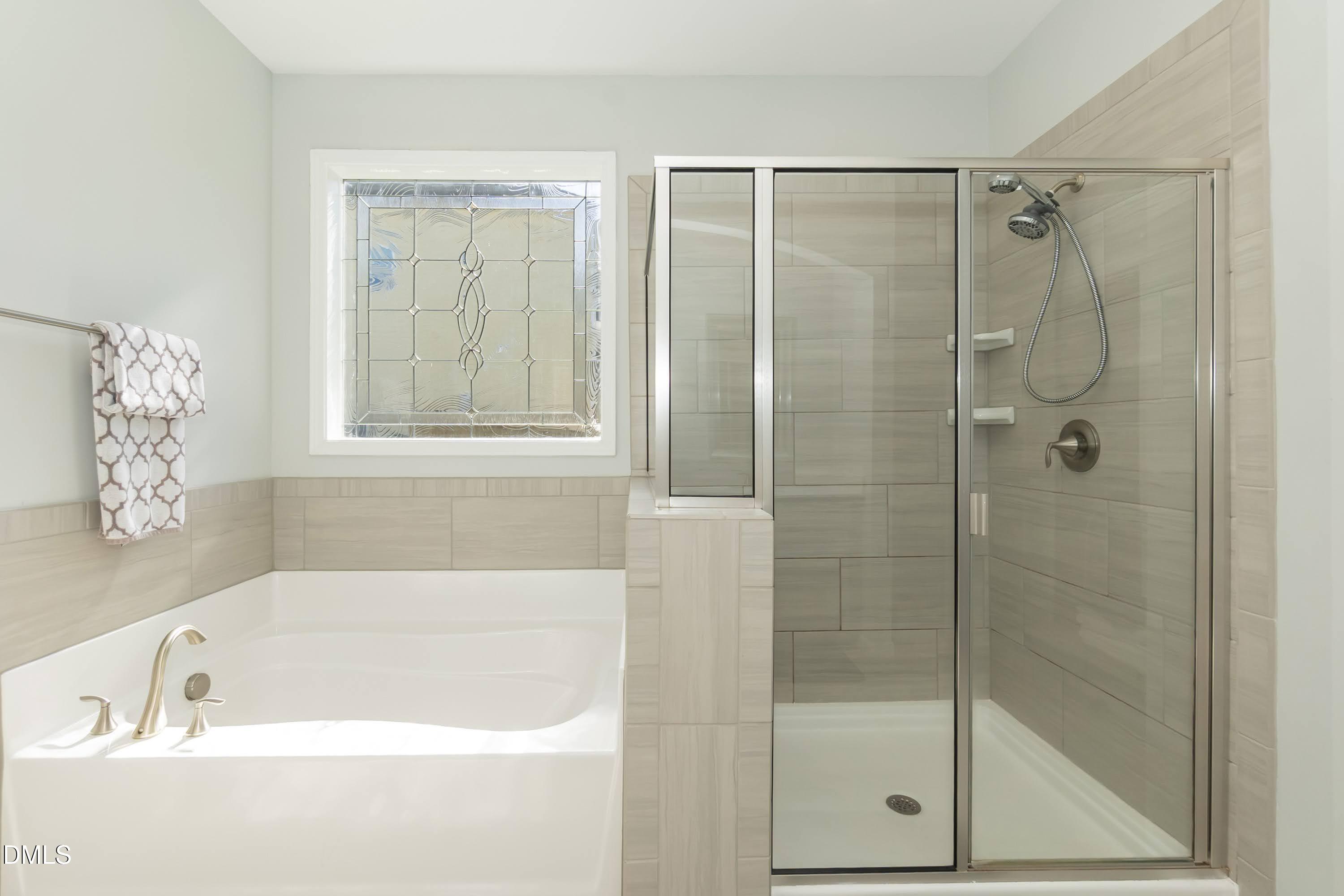 1009 Crescent Moon Court Durham, NC 27712 - Photo 43 of 57 a bathroom with a bathtub and shower