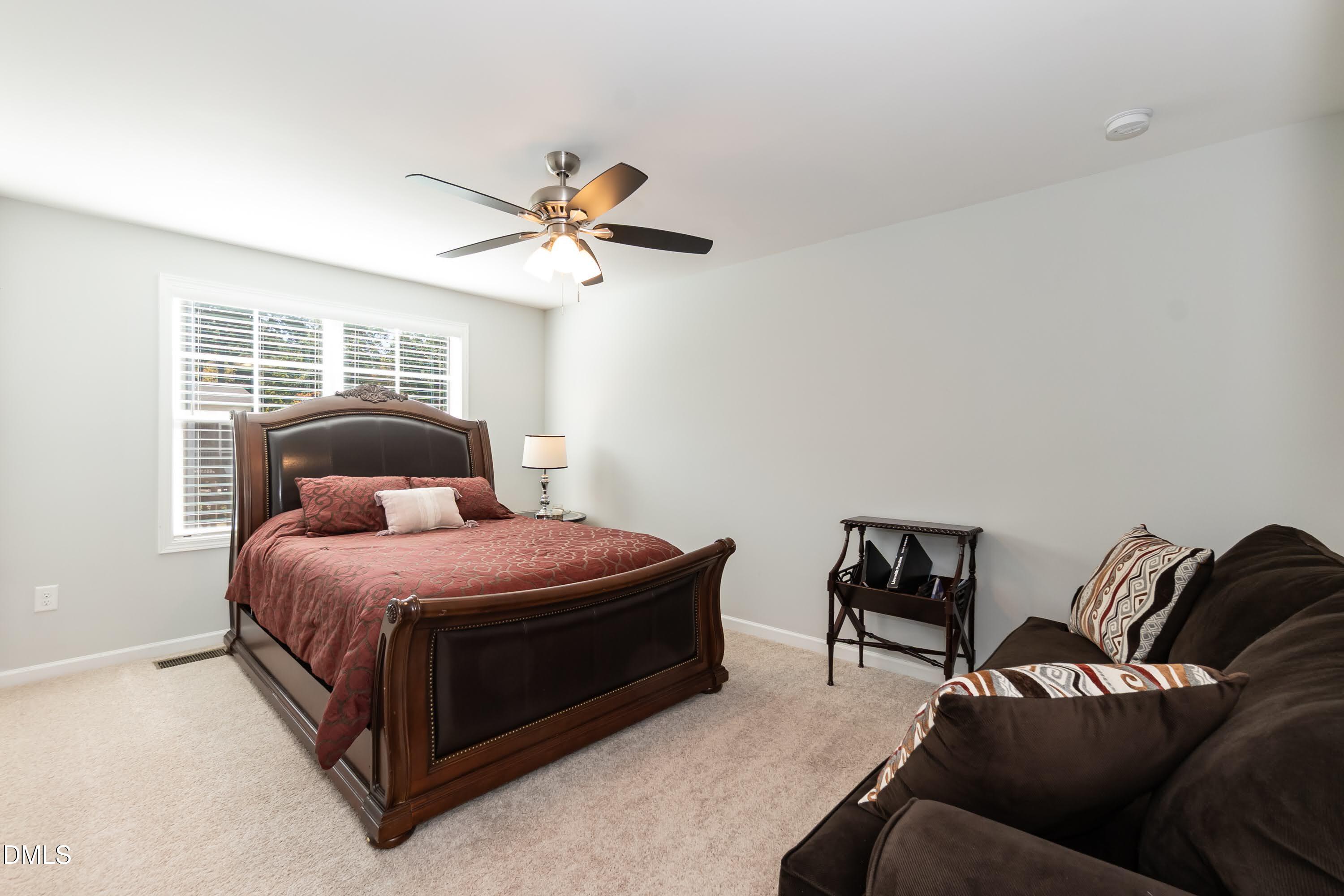 1009 Crescent Moon Court Durham, NC 27712 - Photo 48 of 57 a bedroom with a bed couch and window