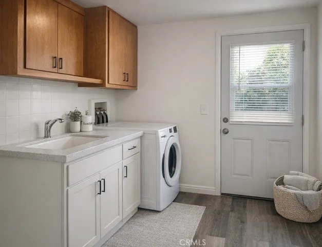 a utility room with sink dryer and washer
