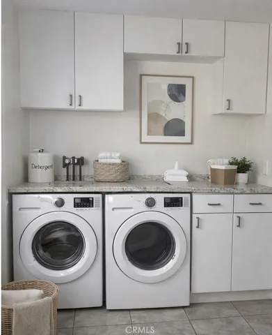 a utility room with sink dryer and washer