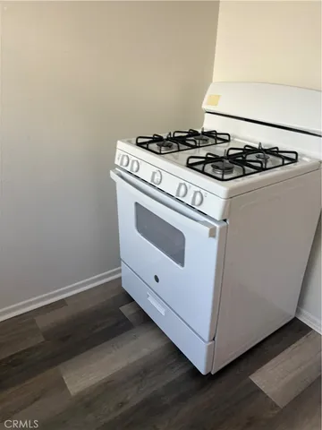 a white stove top oven sitting inside of a kitchen