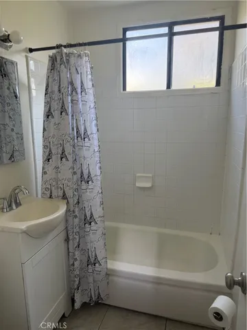 a bathroom with a shower curtain and a sink