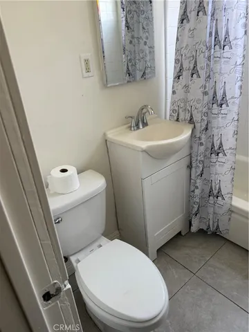 a white toilet sitting next to a bathroom sink