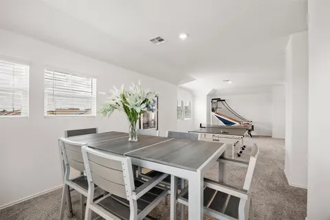 a view of a dining room with furniture and window