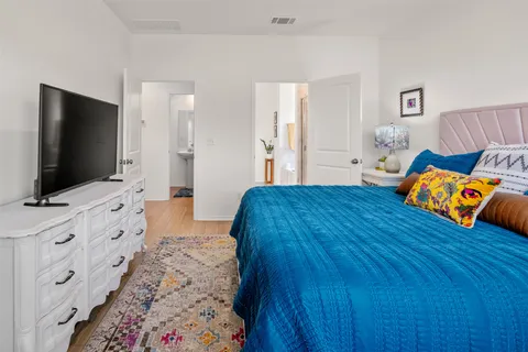 a bedroom with furniture and a flat screen tv