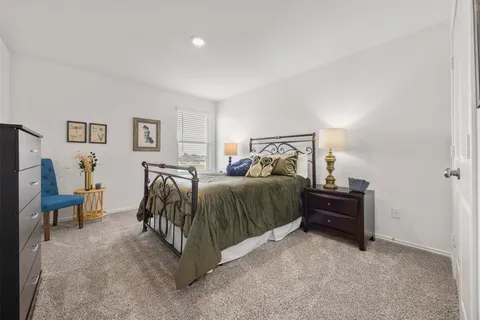 a bedroom with a bed and a chair