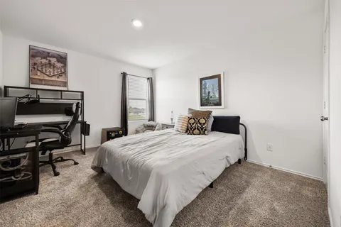 a bedroom with a bed and a desk