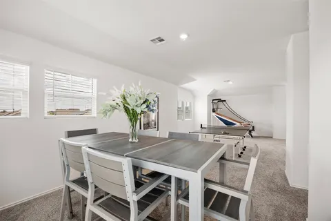 a view of a dining room with furniture and window