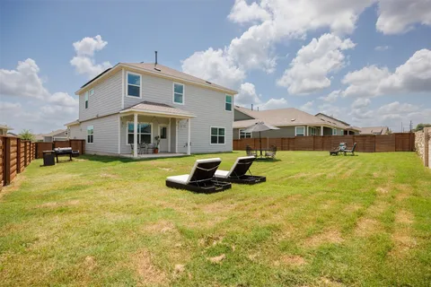 a view of a house with swimming pool and sitting area