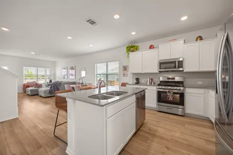 a kitchen with counter top space a sink and appliances