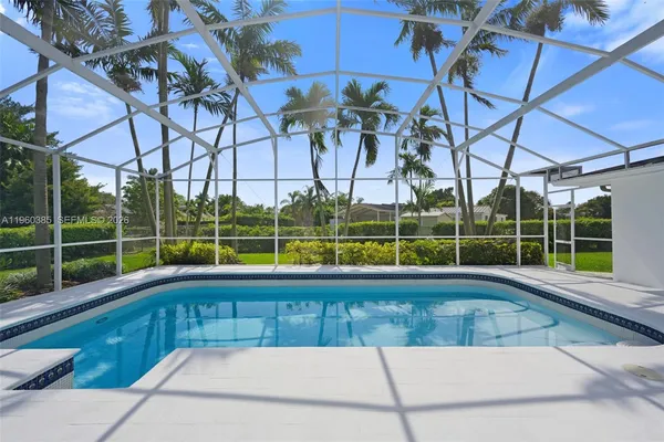 a view of a swimming pool with a yard