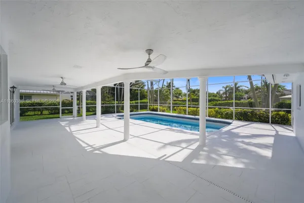 a view of an house with a big yard and large tree