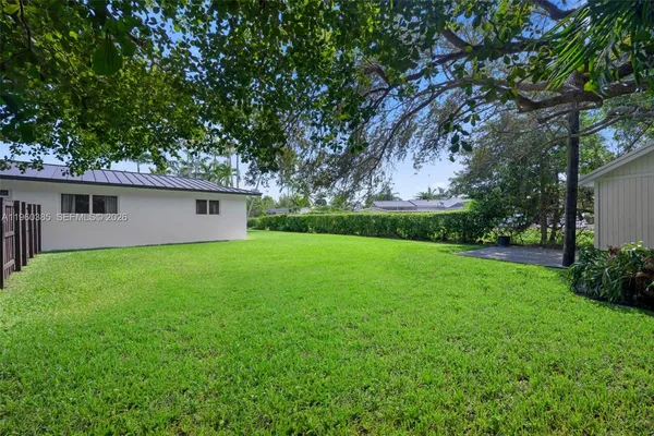 a view of a backyard with large trees